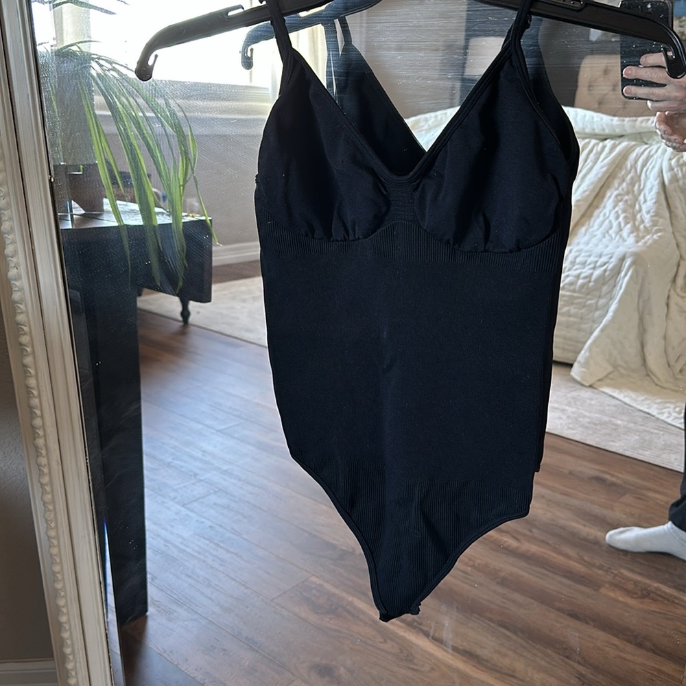 Women’s size large shape wear bodysuit with snaps at bottom . Never worn new.